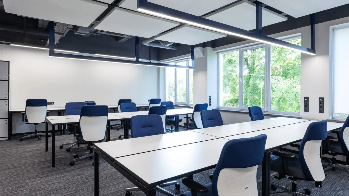 Photo d'un open space parfaitement propre et rangé. Les couleurs sont grises et bleu foncé, comme le logo de MP Solutions, entreprise de nettoyage à Clermont Ferrand.